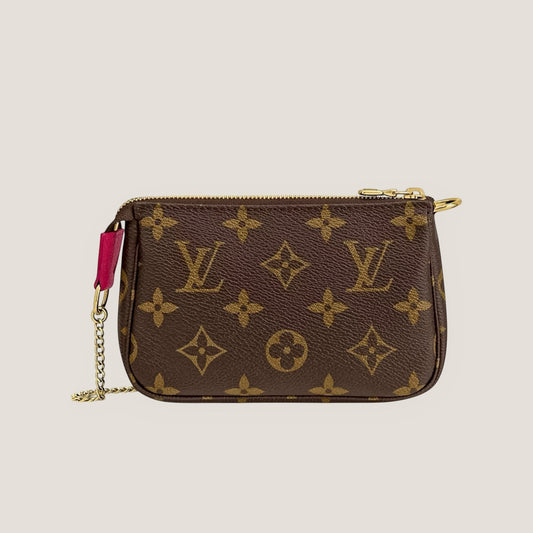 EDIT8 COLLECTIVE Louis Vuitton Mini Pochette Accessoires Vivienne in Switzerland limited edition monogram canvas pouch with gold hardware and pink trim.