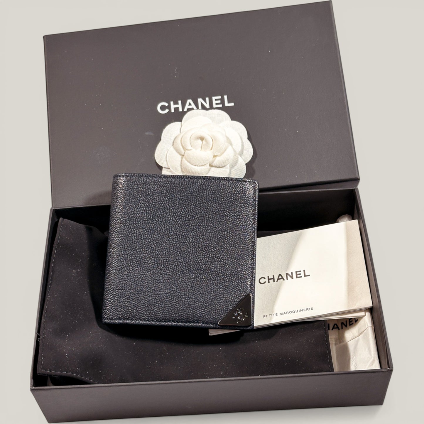EDIT8 COLLECTIVE black caviar leather Chanel bifold wallet with card slots and bill compartments.
