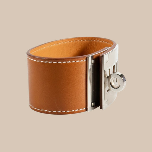 EDIT 8 COLLECTIVE Hermès Kelly Dog bracelet in gold swift leather with palladium hardware and iconic turn-lock closure.