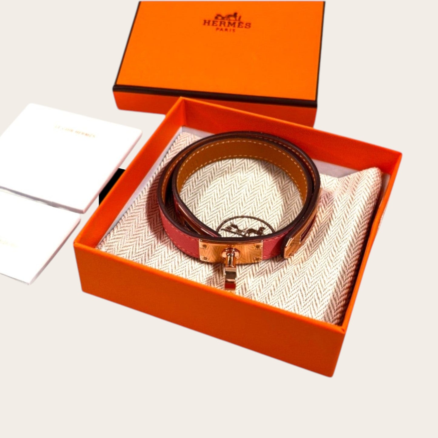Hermès Kelly Double Tour bracelet in Rose Sakura Swift leather with rose gold-plated hardware and Touret clasp.
