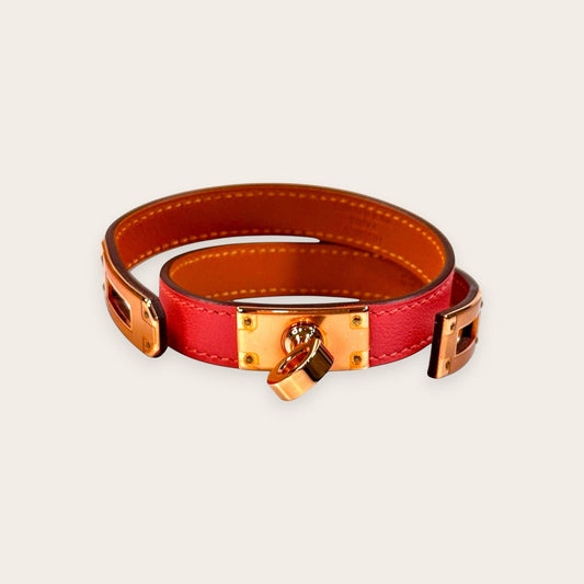 Hermès Kelly Double Tour bracelet in Rose Sakura Swift leather with rose gold-plated hardware and iconic Touret clasp.