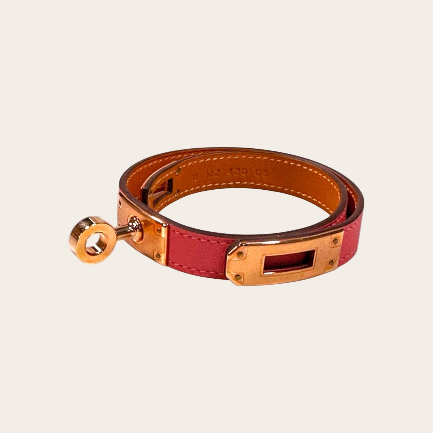 Hermès Kelly Double Tour bracelet in Rose Sakura Swift leather with rose gold-plated hardware and Touret clasp.