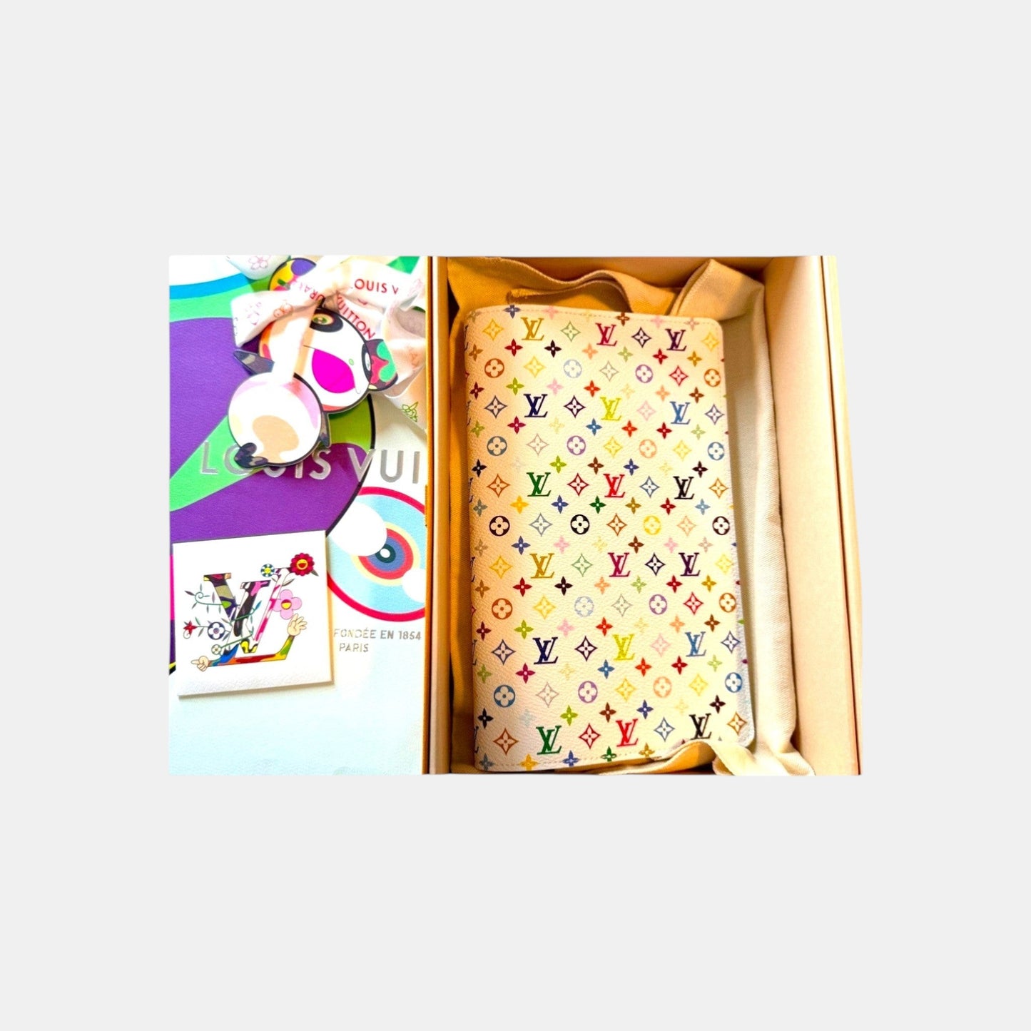 EDIT8 COLLECTIVE Louis Vuitton x Murakami white canvas notebook cover with multicolor monogram and floral details.